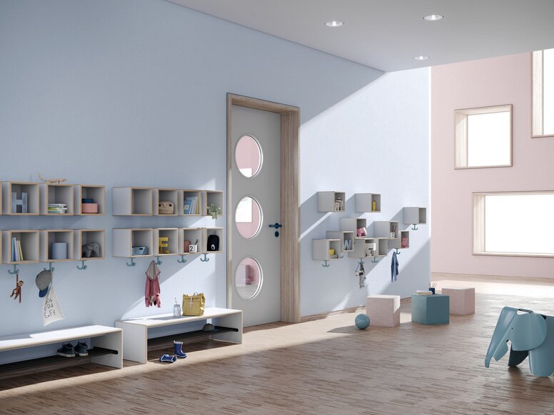 Blue-coloured kindergarten corridor with wall-mounted coat racks, triple hooks and seating