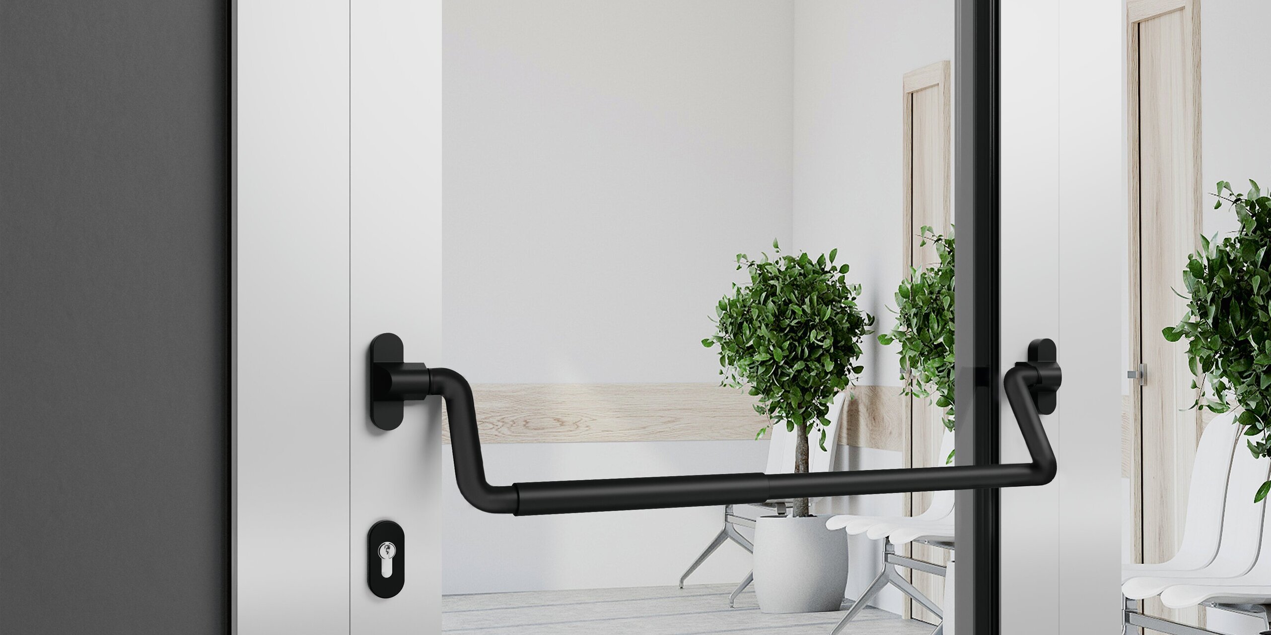 A black panic bar with rounded corners on a glass door with a silver frame