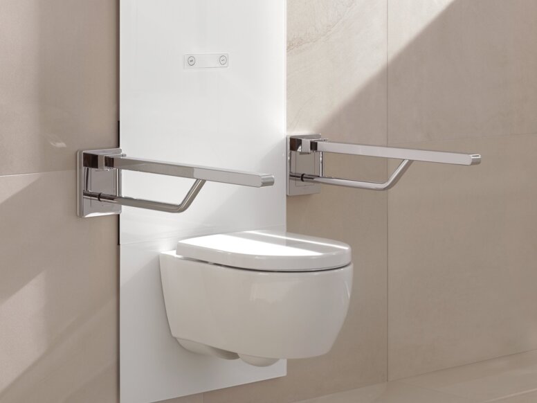 A white, wall-mounted WC module with two hinged support rails on the left and right, set against a beige tiled wall