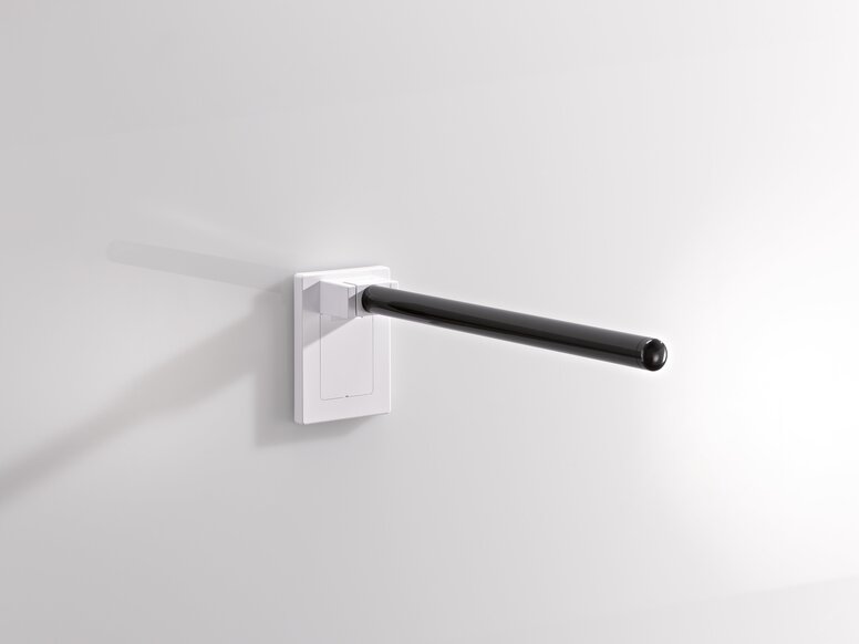 Hinged support rail made of black synthetic material with a white synthetic material fitting on a white wall