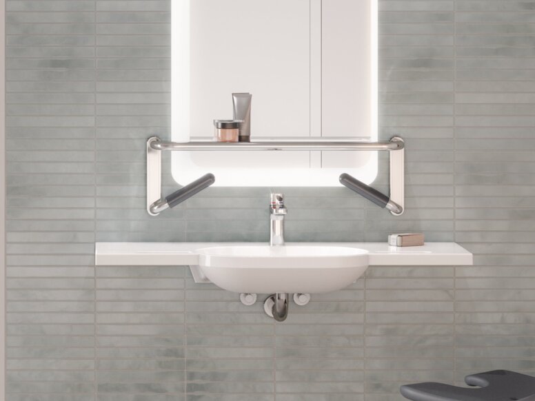HEWI Range 802 LifeSystem Interior A shower seat and handrail attached to a rail with shower head holder in a shower area, next to which is a washbasin mounted on a tiled wall
