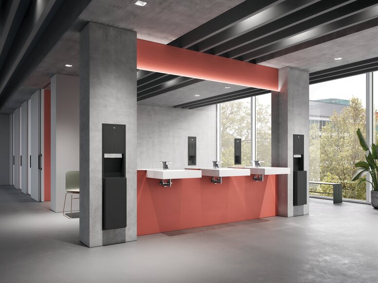 HEWI System 900 Concealed Fitting Three washbasins in the public area, set against grey-and-red concrete walls, with paper and soap dispensers recessed into the wall