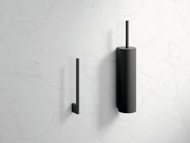 HEWI System 900 spare roll holder and toilet brush unit Black powder-coated toilet roll holder and black toilet brush holder on a white marble wall