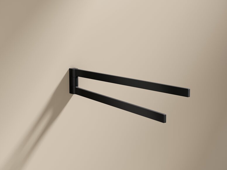 HEWI System 900Q Towel Holder Black powder-coated towel holder with two arms on a beige wall