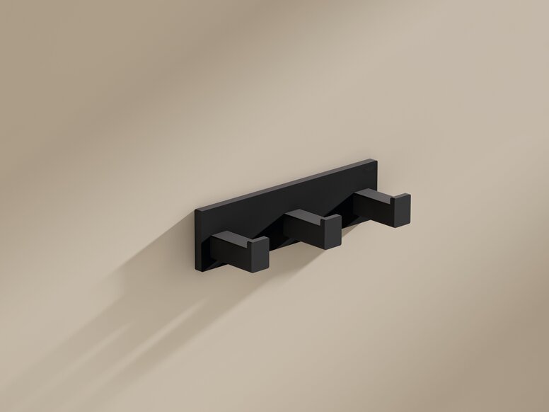 HEWI System 900Q hook rail Black powder-coated coat rack with three square hooks on a beige wall