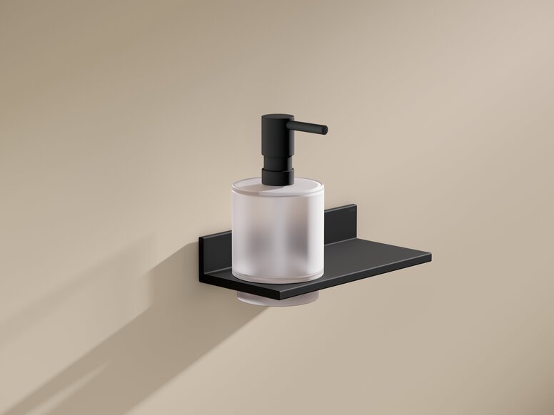 HEWI System 900Q shelf with soap or disinfectant dispenser Black powder-coated wall bracket with soap dispenser and flat shelf on a beige-coloured wall