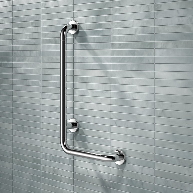 A chrome-plated L-shaped support rail mounted on a wall in front of light blue tiles