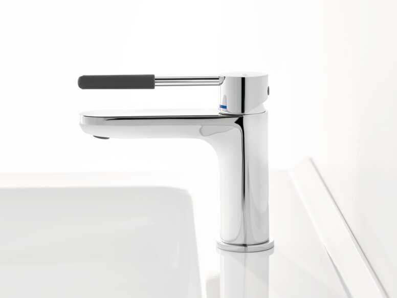 Chrome-plated tap with a long lever handle and dark grey grip sleeve on a white washbasin against a white background