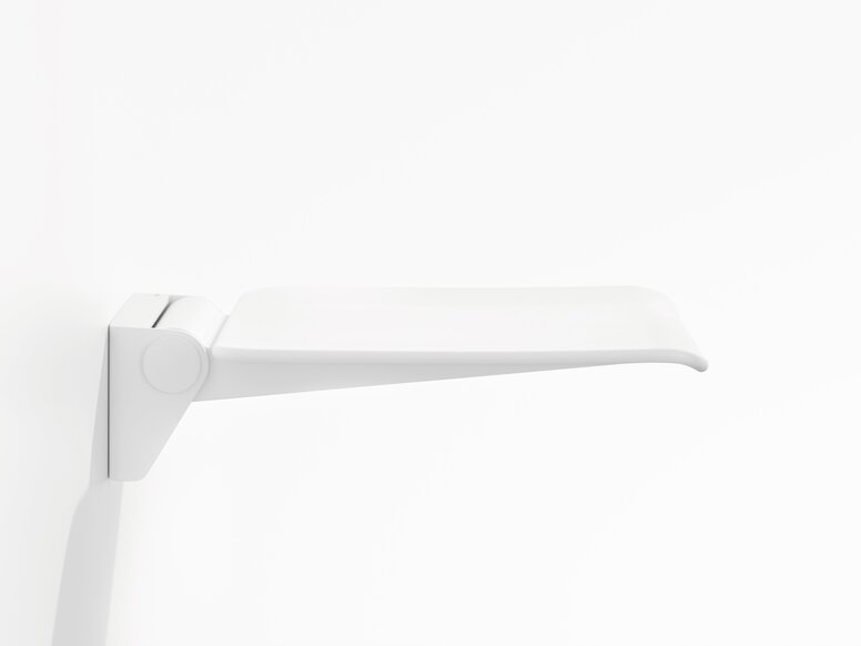 White wall-mounted hinged seat with a flat seating surface and rounded front edge against a white background, viewed from the side